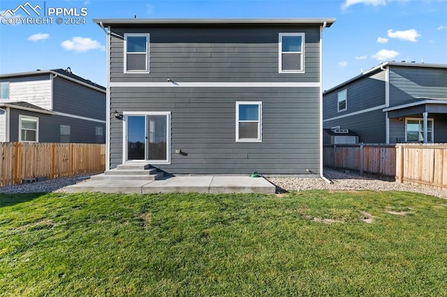 rear view of property with a lawn