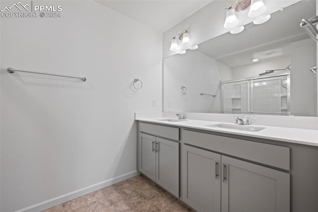 bathroom with a shower with door and vanity