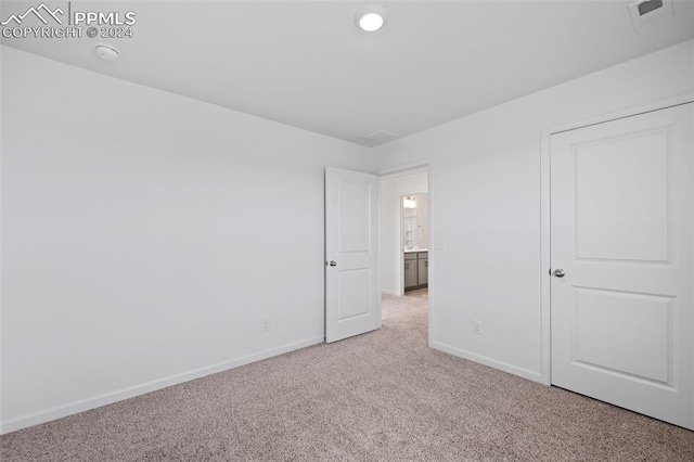 unfurnished bedroom with light colored carpet