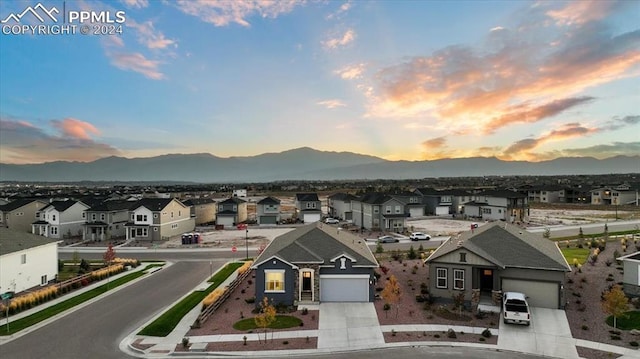 aerial view at dusk featuring a mountain view