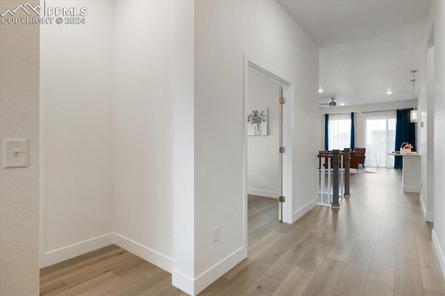 hallway with light hardwood / wood-style floors