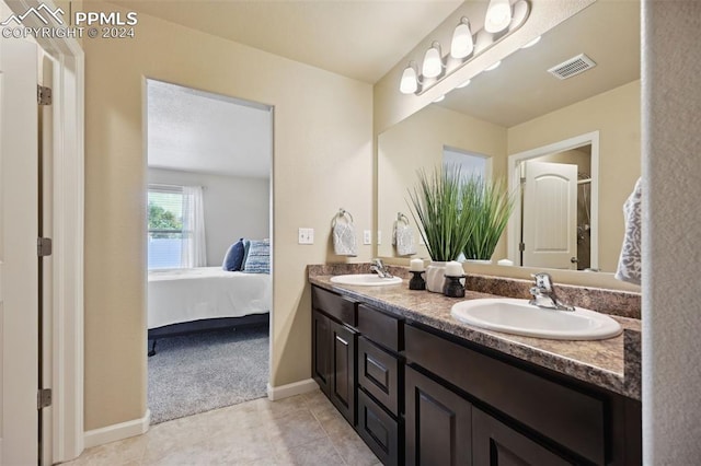 bathroom with tile patterned flooring and vanity