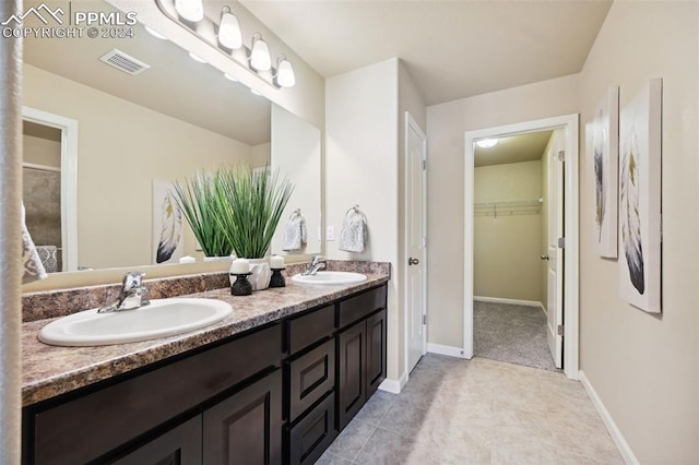 bathroom featuring tile patterned flooring and vanity