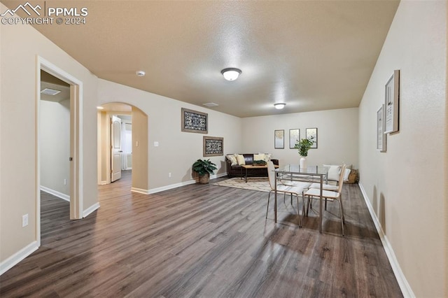 dining area featuring dark hardwood / wood-style floors and a textured ceiling