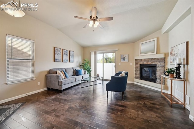 living room featuring ceiling fan, a fireplace, dark wood-type flooring, and vaulted ceiling