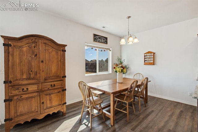 dining room featuring dark hardwood / wood-style floors and a chandelier