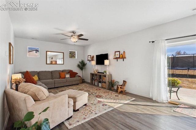 living room with hardwood / wood-style floors and ceiling fan