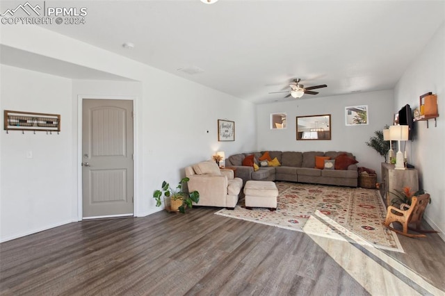 living room with ceiling fan and dark hardwood / wood-style flooring