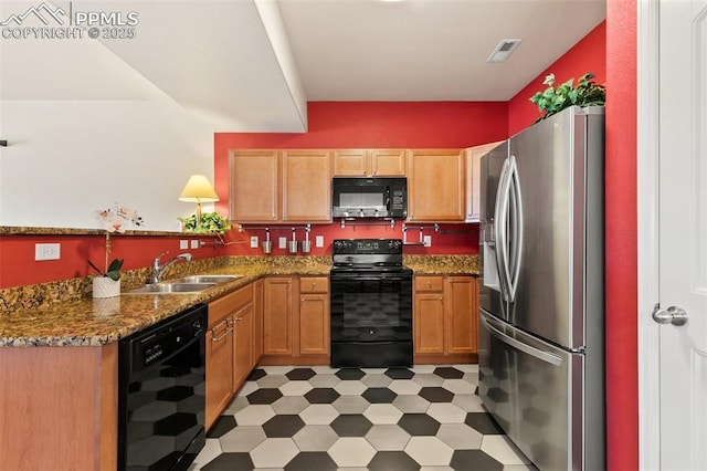 2616 Gilpin Ave, Colorado Springs, CO 80910 - kitchen with black appliances, light flooring, a sink, a peninsula, and dark stone counters