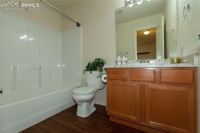 full bathroom with vanity, toilet, bathtub / shower combination, and hardwood / wood-style flooring