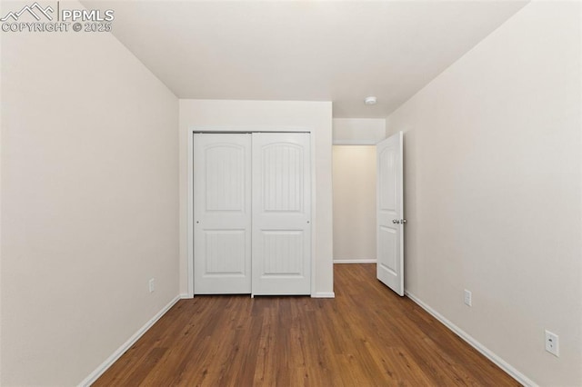 2616 Gilpin Ave, Colorado Springs, CO 80910 - unfurnished bedroom with baseboards, wood finished floors, and a closet
