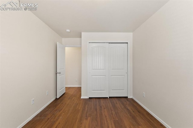 2616 Gilpin Ave, Colorado Springs, CO 80910 - unfurnished bedroom featuring baseboards, dark wood-style floors, and a closet