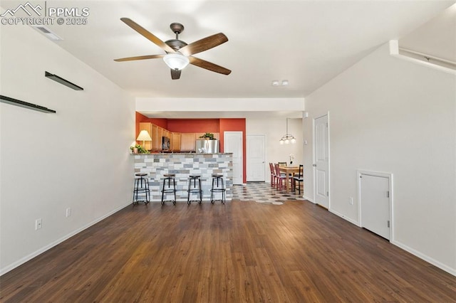 2616 Gilpin Ave, Colorado Springs, CO 80910 - living room with a ceiling fan, dark wood-style flooring, and baseboards