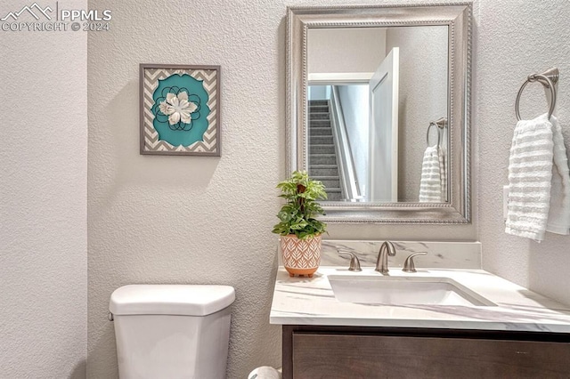 bathroom featuring toilet and vanity