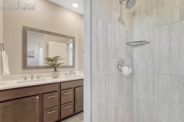 bathroom featuring vanity and tiled shower