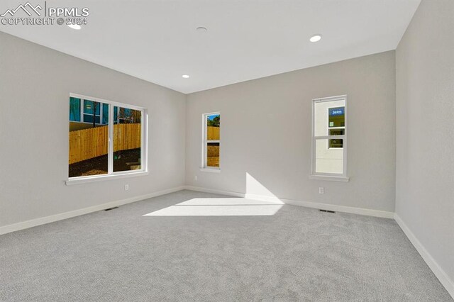 unfurnished room with light carpet
