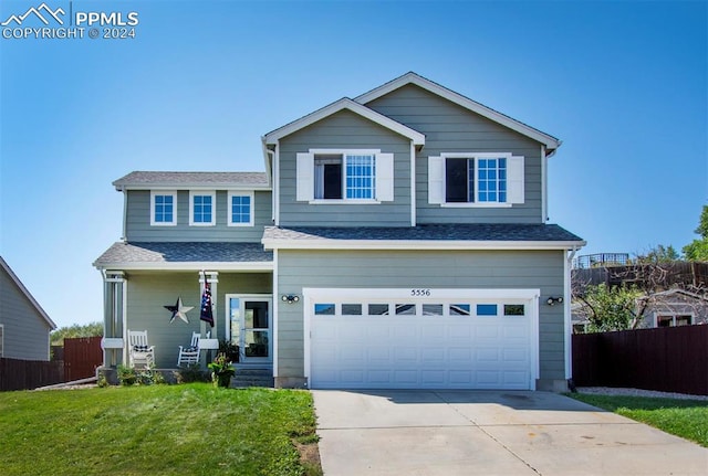 view of front of home featuring a garage and a front lawn