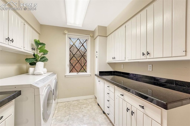 clothes washing area featuring independent washer and dryer, cabinets, and light tile patterned floors