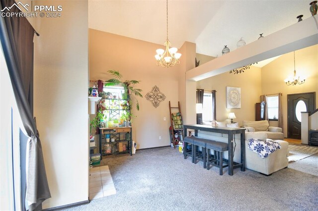 living room with carpet flooring, high vaulted ceiling, and an inviting chandelier