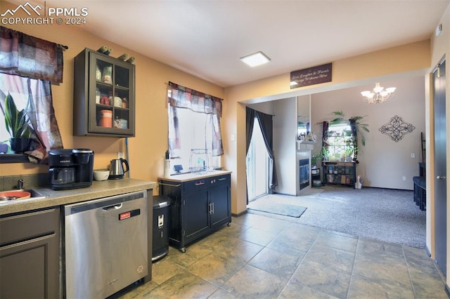 kitchen with a notable chandelier, dishwasher, light carpet, and decorative light fixtures