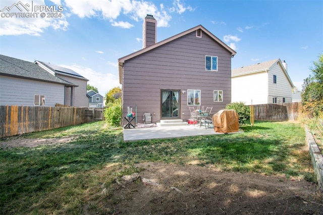 back of house with a yard and a patio area