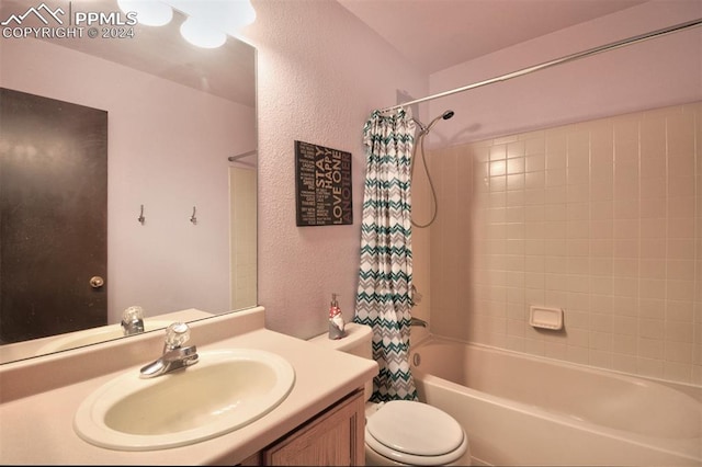 full bathroom featuring vanity, shower / bathtub combination with curtain, and toilet