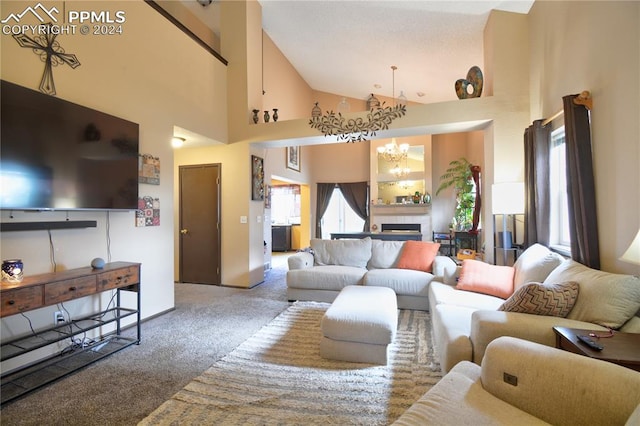 carpeted living room with a tile fireplace, high vaulted ceiling, and an inviting chandelier