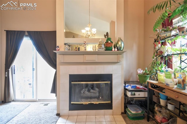 interior details featuring tile patterned flooring, a fireplace, and a notable chandelier