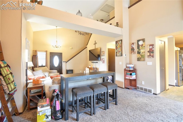 kitchen with stainless steel fridge, light carpet, high vaulted ceiling, and a chandelier