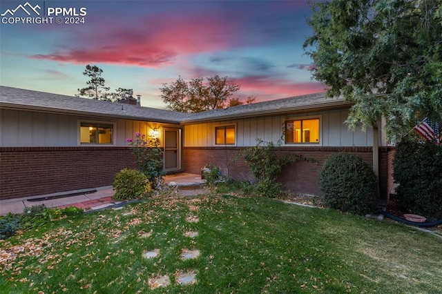 ranch-style house with a yard