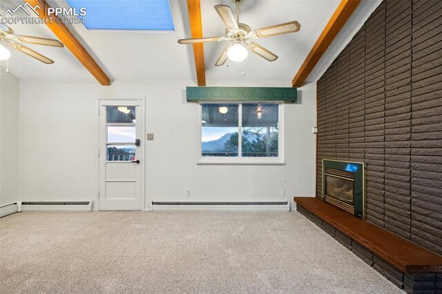 unfurnished living room featuring a baseboard heating unit, beamed ceiling, carpet, and a brick fireplace