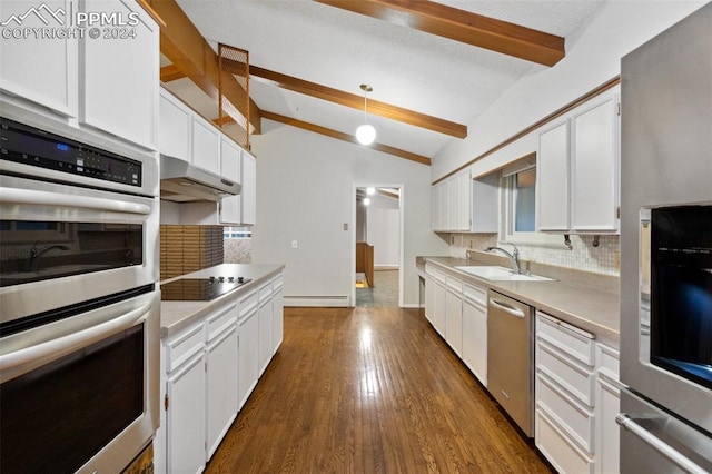 kitchen featuring stainless steel appliances, sink, lofted ceiling with beams, and white cabinets