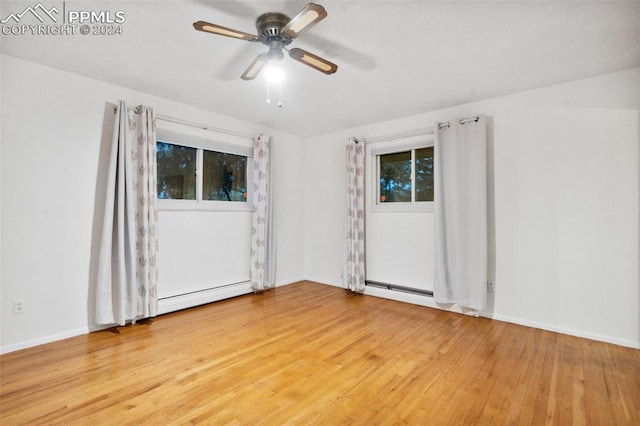 empty room featuring ceiling fan and hardwood / wood-style floors