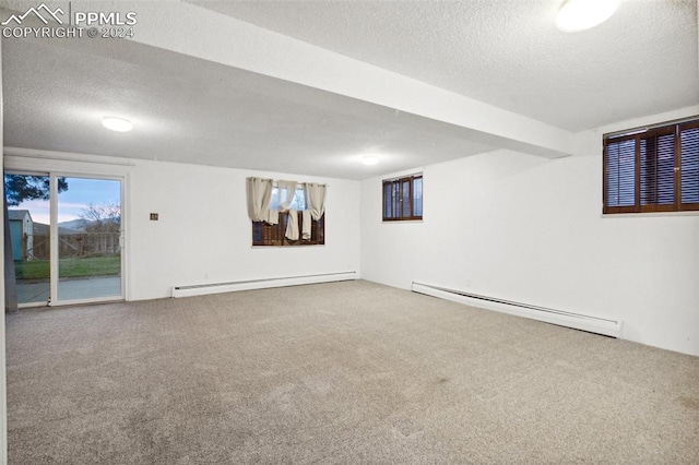 basement with carpet floors, a textured ceiling, and a baseboard radiator