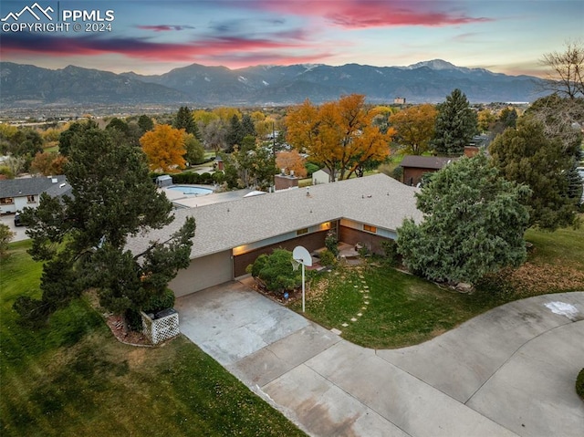 aerial view at dusk featuring a mountain view