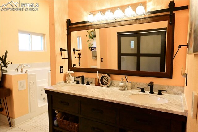 bathroom with tile patterned flooring, vanity, and a bathtub