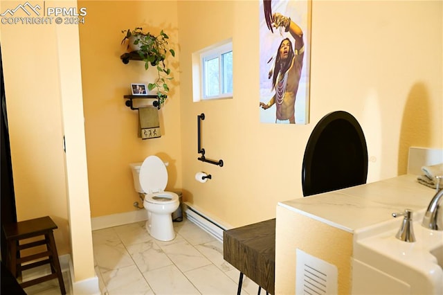 bathroom featuring baseboard heating and toilet