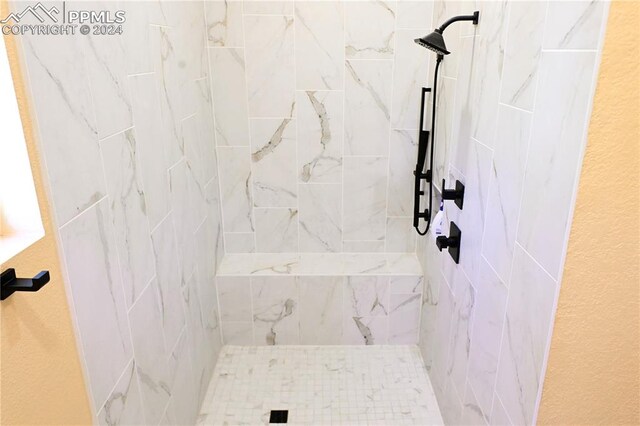 bathroom with a tile shower