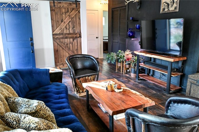 living room with dark wood-type flooring and a barn door