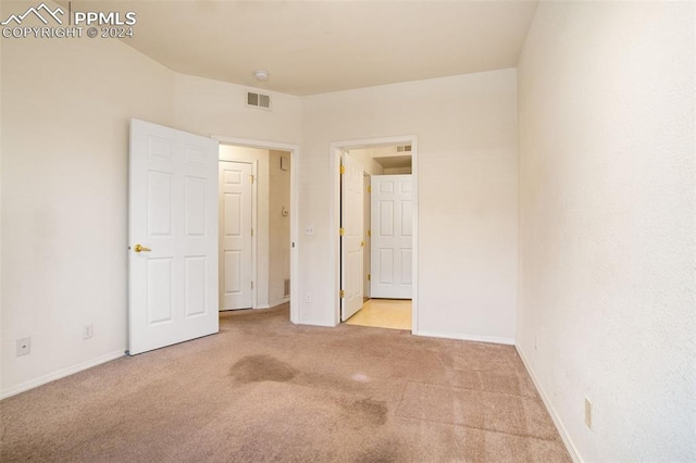 unfurnished bedroom featuring light carpet