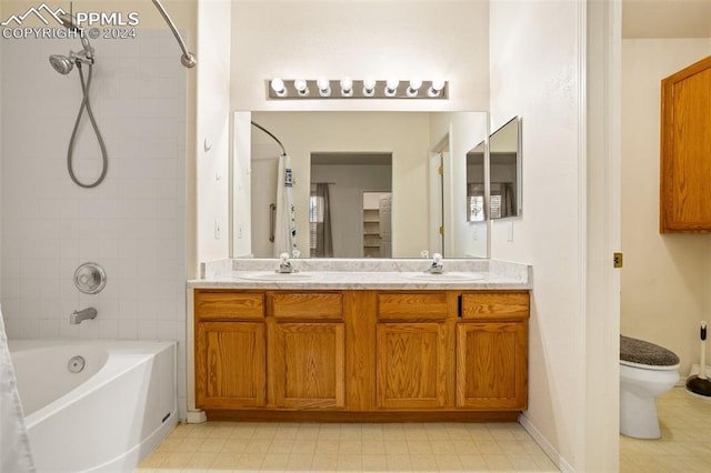 full bathroom with vanity, toilet, and tiled shower / bath combo