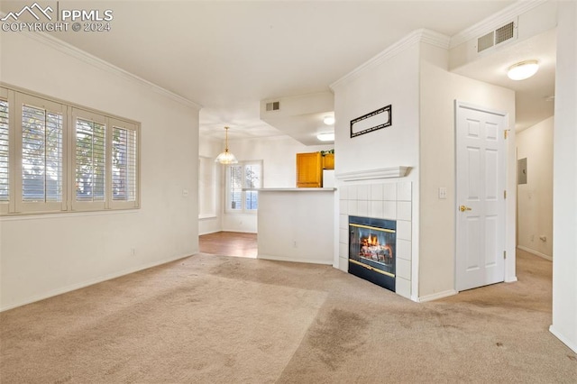 unfurnished living room with a fireplace, a wealth of natural light, light colored carpet, and crown molding