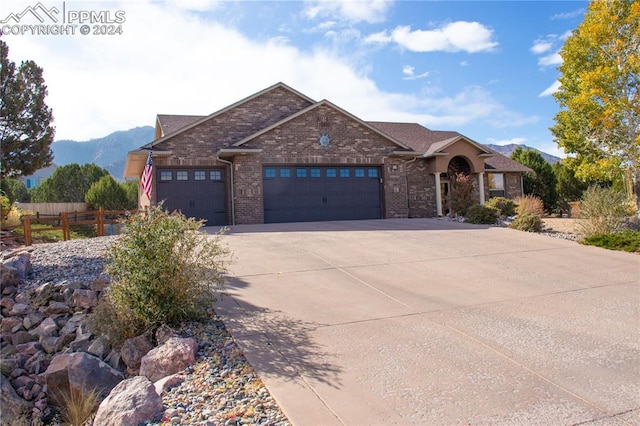 view of front of home featuring a mountain view and a garage