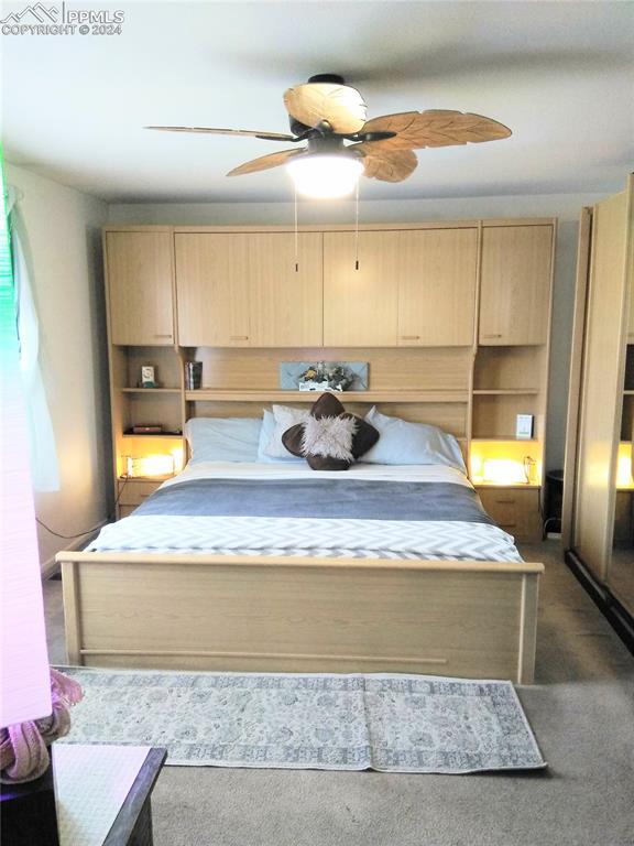 carpeted bedroom featuring ceiling fan