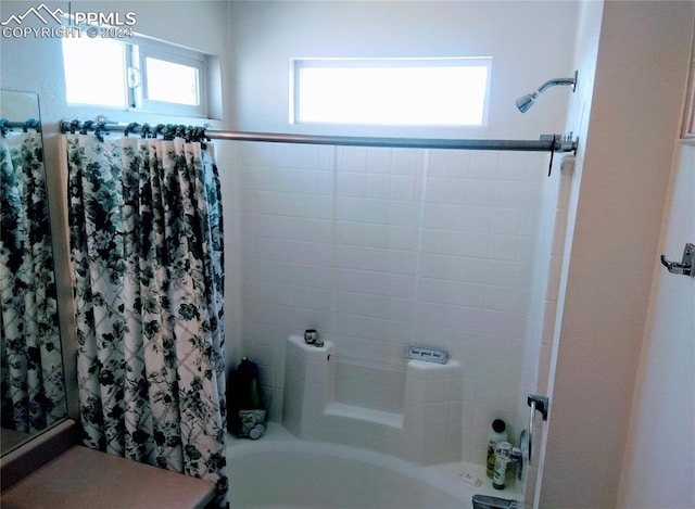 bathroom featuring shower / bath combo with shower curtain