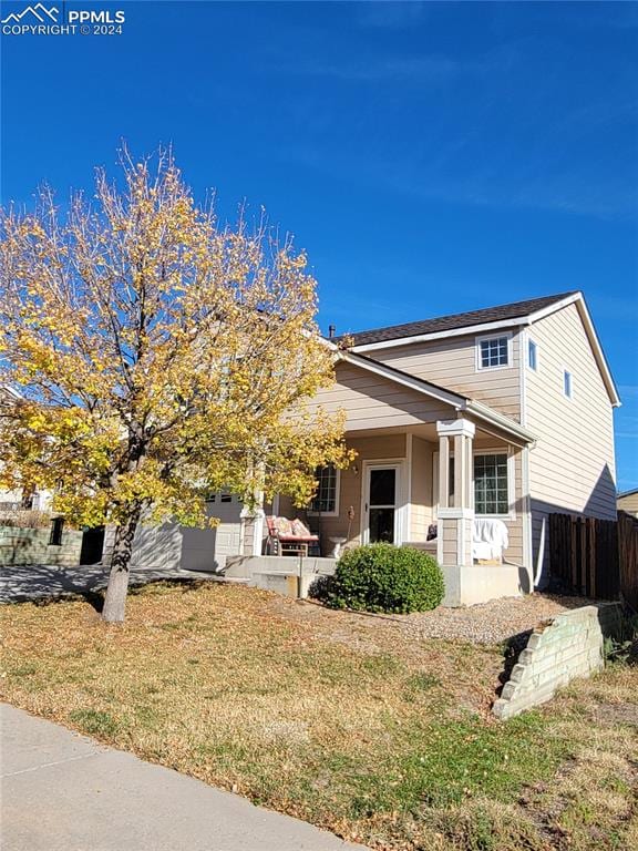 view of front of home with a porch and a front yard