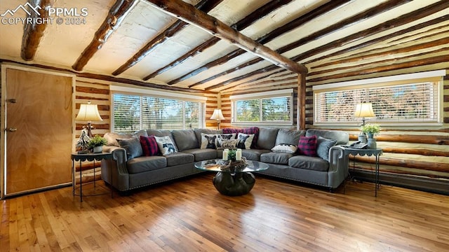 living room with wood-type flooring and vaulted ceiling with beams