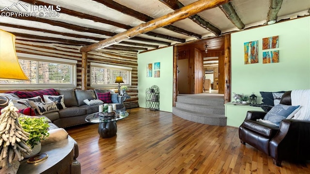 living room with hardwood / wood-style floors and beamed ceiling