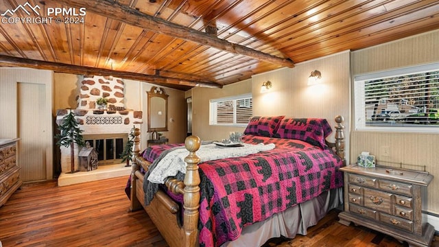 bedroom featuring a fireplace, beamed ceiling, hardwood / wood-style flooring, and wood ceiling