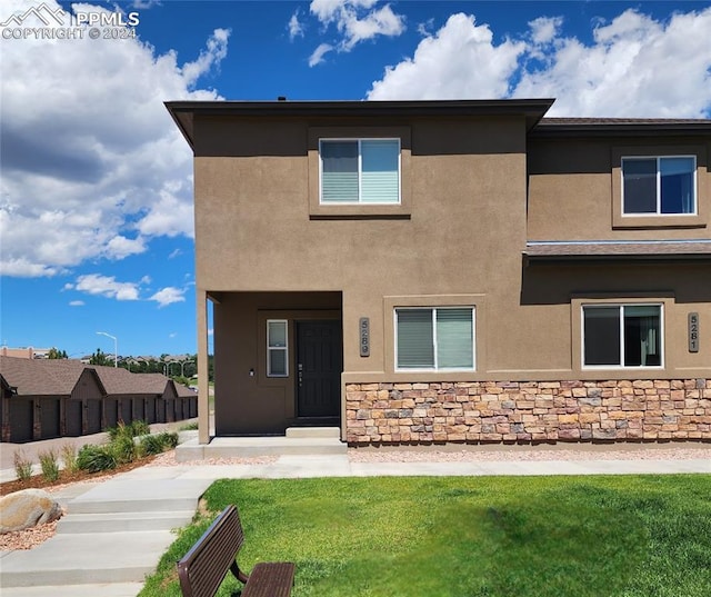 rear view of property with a yard